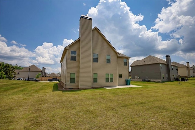 200 Baumgard, Locust Grove, GA 30248 - rear view of house featuring a patio, a yard, and a chimney