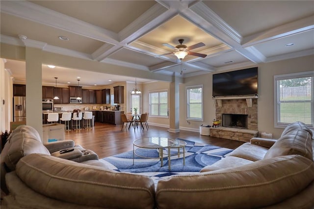 200 Baumgard, Locust Grove, GA 30248 - living room featuring dark wood-style flooring, healthy amount of natural light, beam ceiling, a stone fireplace, and recessed lighting