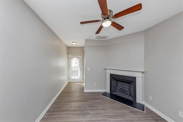 unfurnished living room featuring ceiling fan and wood-type flooring