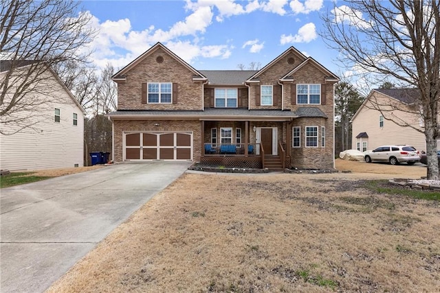 view of front of home featuring a porch and a garage