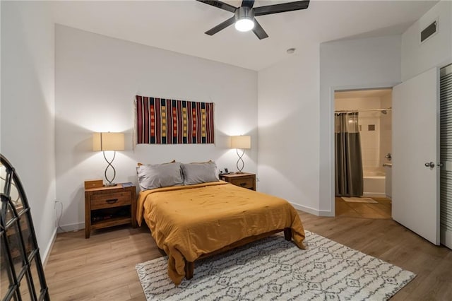 bedroom featuring ensuite bath, ceiling fan, and light hardwood / wood-style flooring