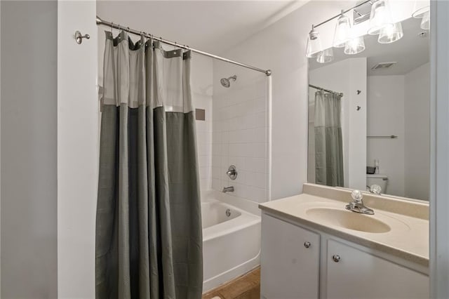 bathroom featuring shower / bath combo and vanity