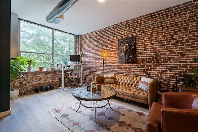 living room with light wood-type flooring and brick wall