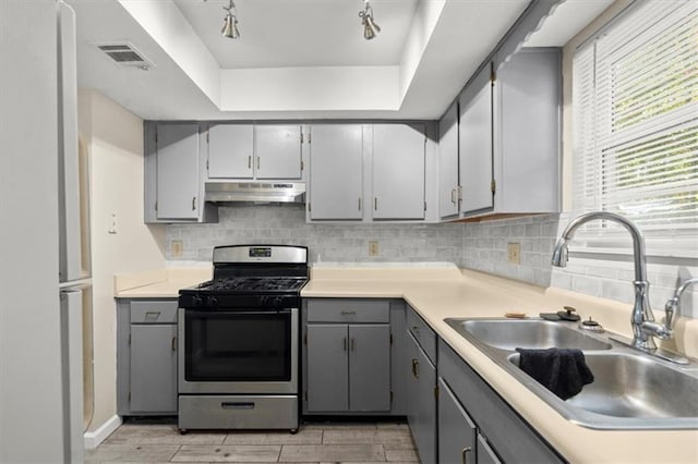 kitchen featuring gray cabinets, sink, and stainless steel gas range