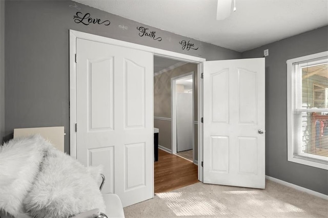 carpeted bedroom with ceiling fan