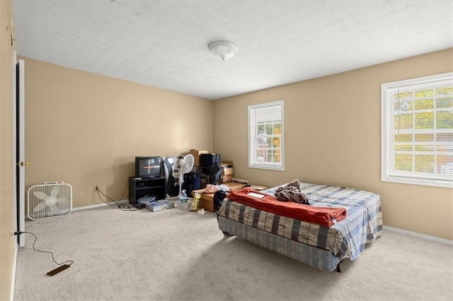 bedroom featuring carpet flooring and a textured ceiling