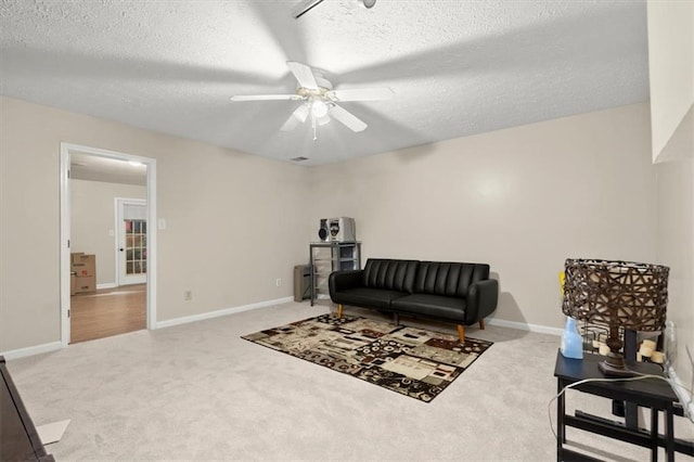 carpeted living room with a textured ceiling and ceiling fan