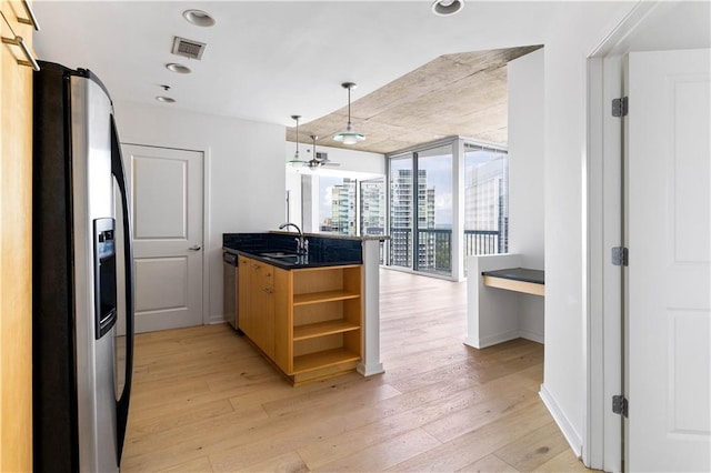 3324 Peachtree Rd NE Unit 2518, Atlanta, GA 30326 - kitchen with appliances with stainless steel finishes, open shelves, a peninsula, light wood-style flooring, and dark countertops