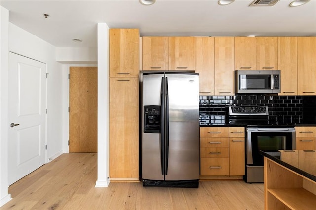 3324 Peachtree Rd NE Unit 2518, Atlanta, GA 30326 - kitchen featuring appliances with stainless steel finishes, dark countertops, light wood-style flooring, tasteful backsplash, and light brown cabinets
