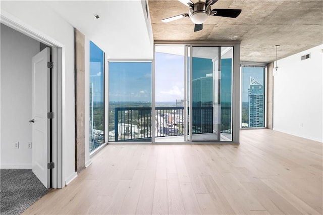 3324 Peachtree Rd NE Unit 2518, Atlanta, GA 30326 - empty room featuring a wall of windows, wood finished floors, and a ceiling fan