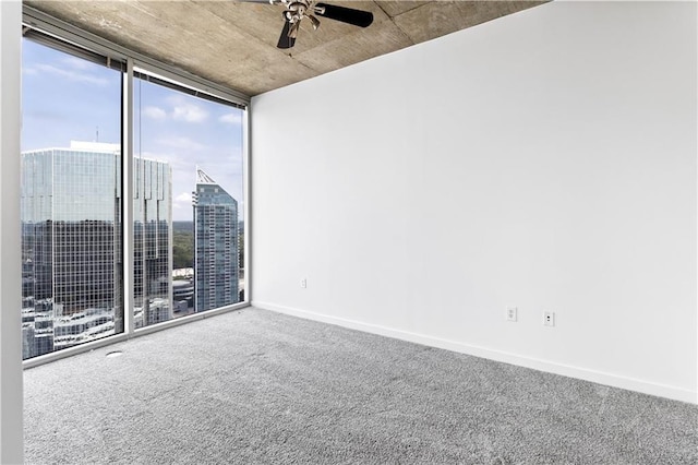 3324 Peachtree Rd NE Unit 2518, Atlanta, GA 30326 - empty room featuring a ceiling fan, expansive windows, carpet flooring, and a view of city