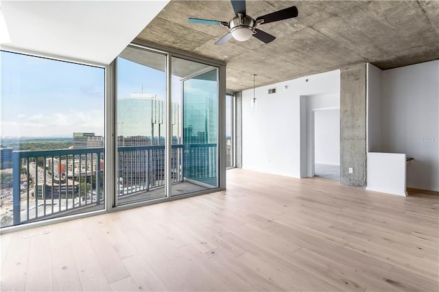 3324 Peachtree Rd NE Unit 2518, Atlanta, GA 30326 - unfurnished room featuring wood finished floors, floor to ceiling windows, and a ceiling fan