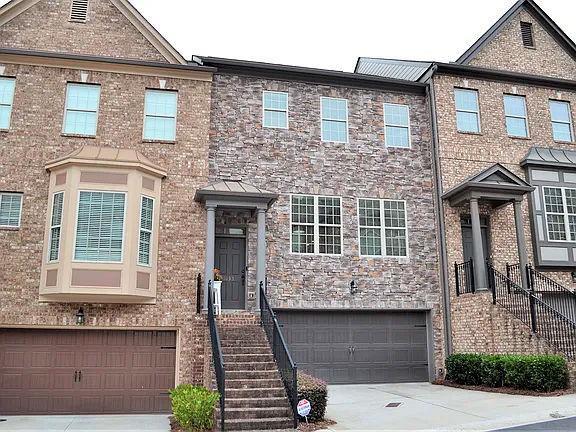 1035 Willow Field Ln SE, Marietta, GA 30067 - view of property with brick siding, an attached garage, and concrete driveway