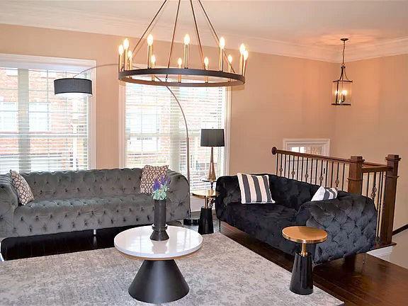 1035 Willow Field Ln SE, Marietta, GA 30067 - living area featuring an inviting chandelier, ornamental molding, and plenty of natural light