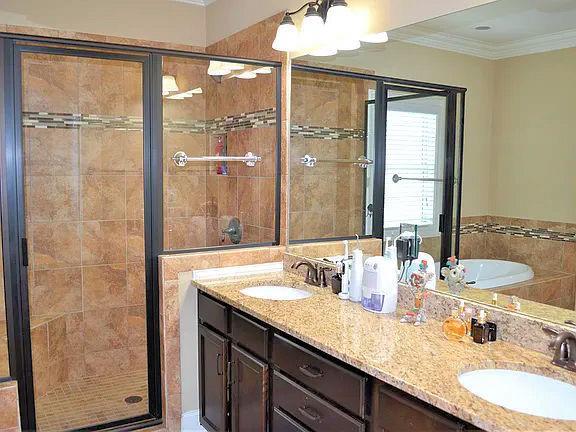 1035 Willow Field Ln SE, Marietta, GA 30067 - full bath featuring a shower stall, crown molding, and a sink