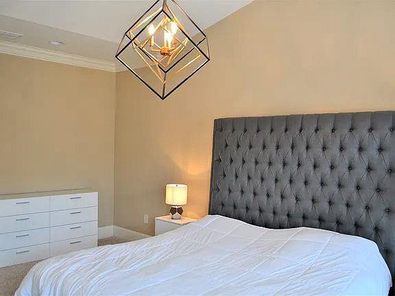 1035 Willow Field Ln SE, Marietta, GA 30067 - bedroom featuring baseboards, ornamental molding, and a chandelier