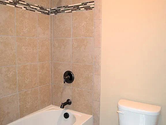 1035 Willow Field Ln SE, Marietta, GA 30067 - bathroom featuring bathing tub / shower combination and toilet