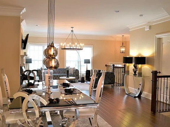 1035 Willow Field Ln SE, Marietta, GA 30067 - dining area featuring wood finished floors, baseboards, ornamental molding, and an inviting chandelier