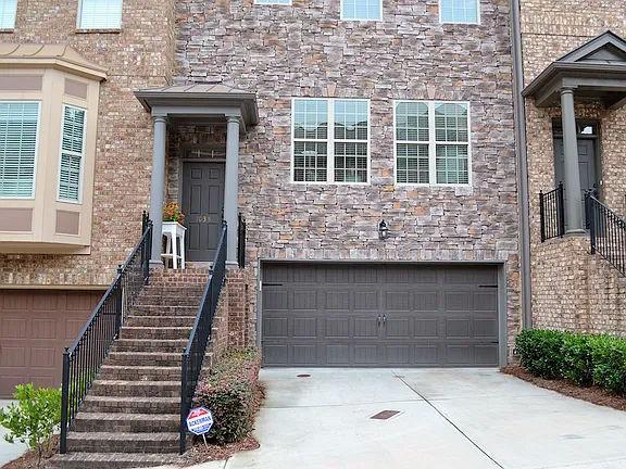 1035 Willow Field Ln SE, Marietta, GA 30067 - doorway to property with stone siding, concrete driveway, and a garage