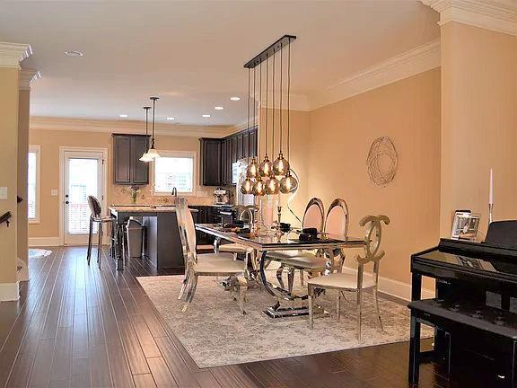 1035 Willow Field Ln SE, Marietta, GA 30067 - dining space featuring baseboards, ornamental molding, and dark wood-style flooring