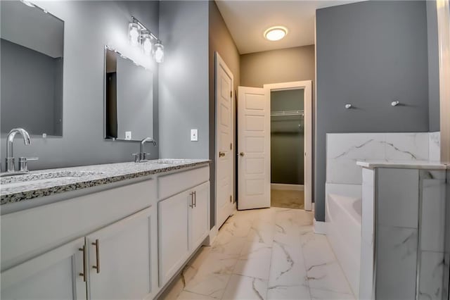 bathroom with vanity and a washtub