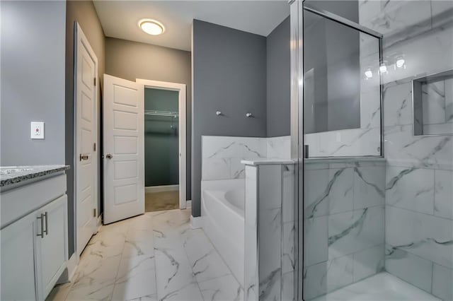 bathroom with vanity and independent shower and bath