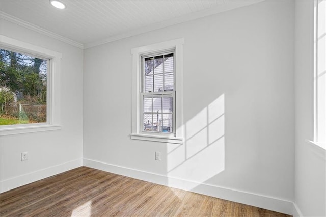 unfurnished room with ornamental molding, recessed lighting, wood finished floors, and baseboards