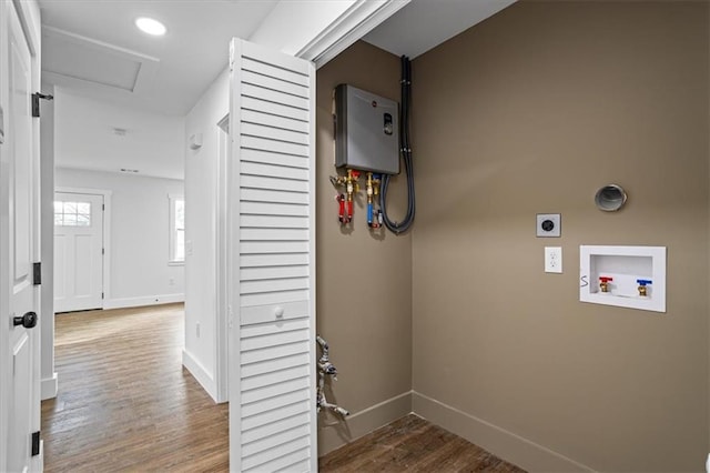 clothes washing area featuring laundry area, baseboards, wood finished floors, hookup for a washing machine, and hookup for an electric dryer