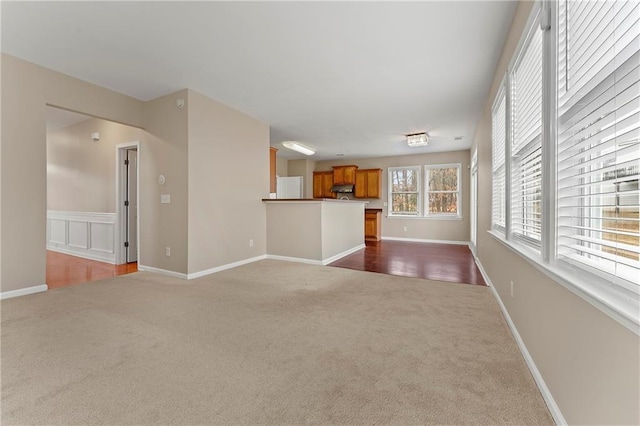 unfurnished living room featuring dark colored carpet