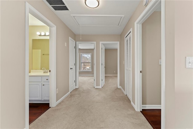 hall with light colored carpet