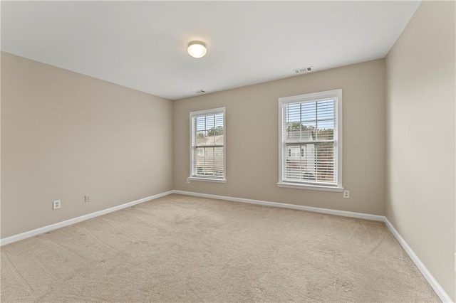 empty room featuring light carpet