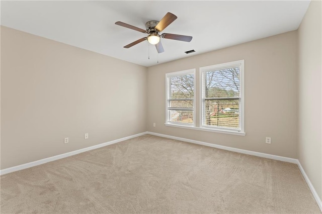 carpeted spare room with ceiling fan