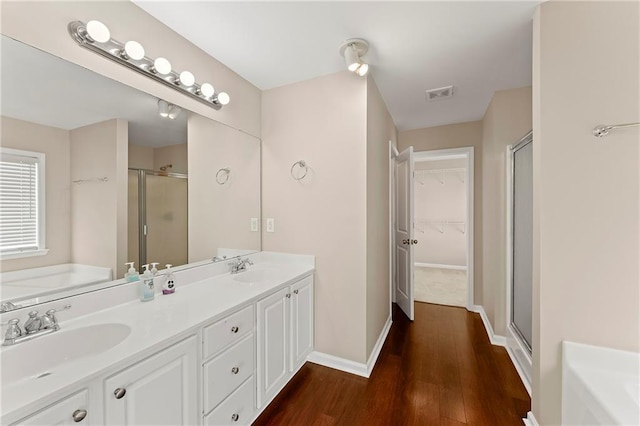 bathroom featuring vanity, shower with separate bathtub, and hardwood / wood-style floors