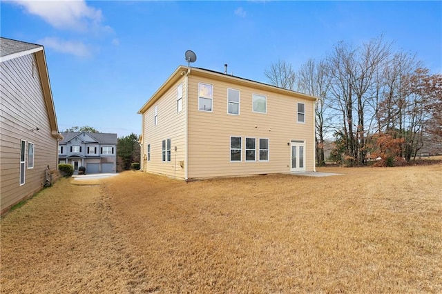 rear view of property with a lawn