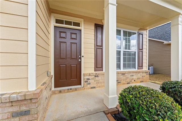 view of exterior entry with central AC unit