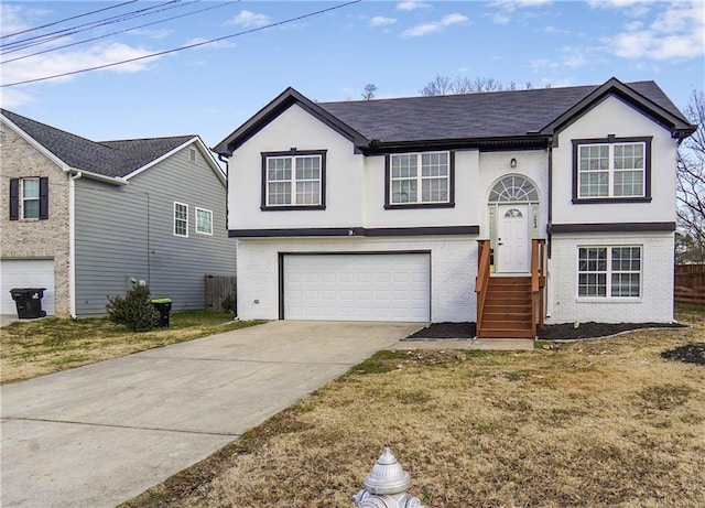 split foyer home with a front yard and a garage