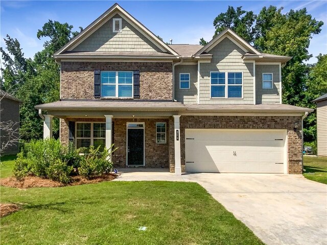 craftsman house with a front lawn and a garage