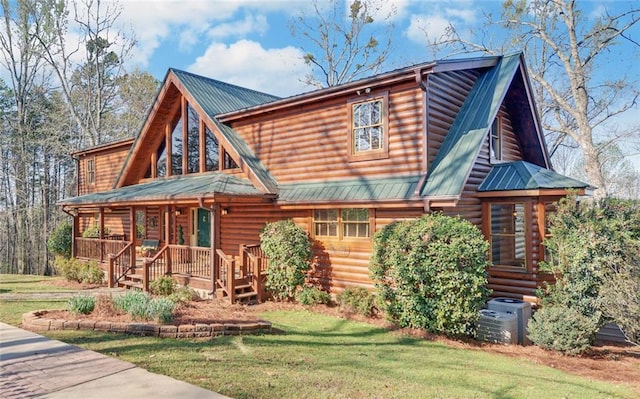 log-style house featuring a front yard, a porch, and central AC