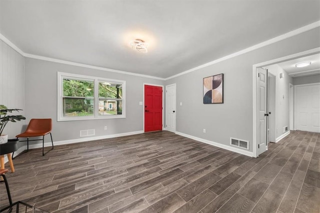 entrance foyer with ornamental molding and dark wood-type flooring