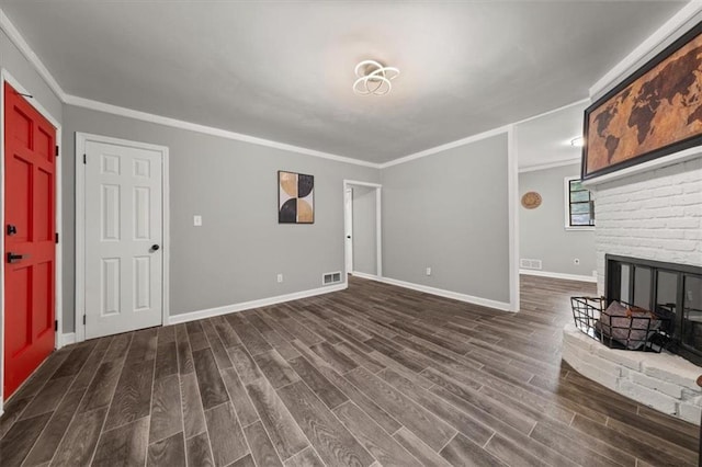 unfurnished living room with a fireplace, crown molding, and dark wood-type flooring