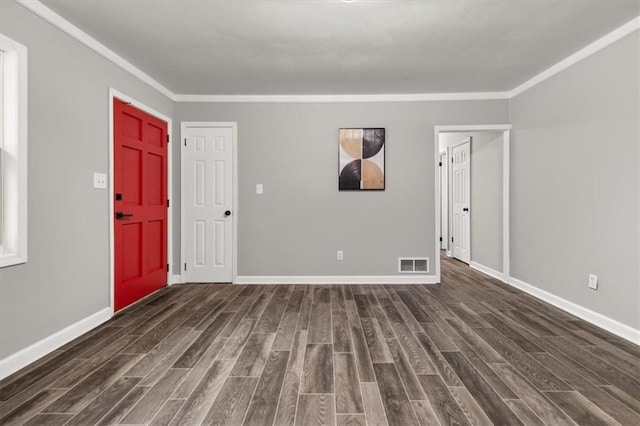 entrance foyer with dark hardwood / wood-style flooring and ornamental molding