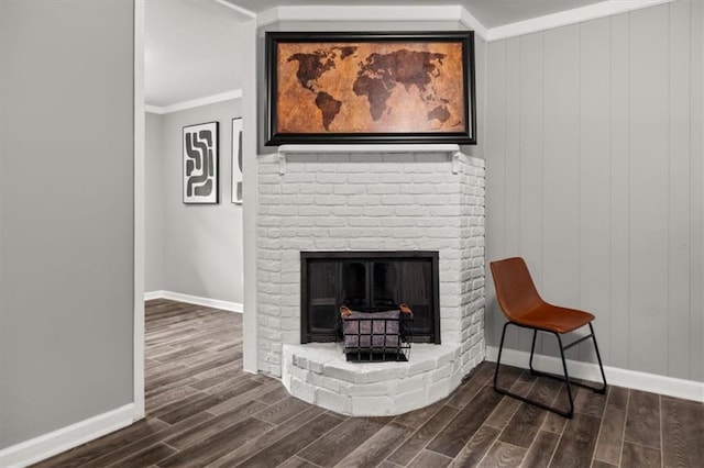 room details with a fireplace, hardwood / wood-style floors, wooden walls, and ornamental molding