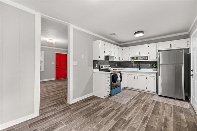 kitchen with backsplash, dark wood-type flooring, white cabinets, sink, and appliances with stainless steel finishes