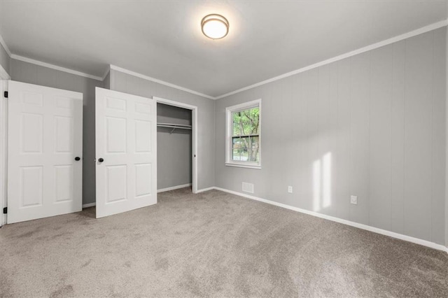 unfurnished bedroom featuring light carpet, a closet, and crown molding