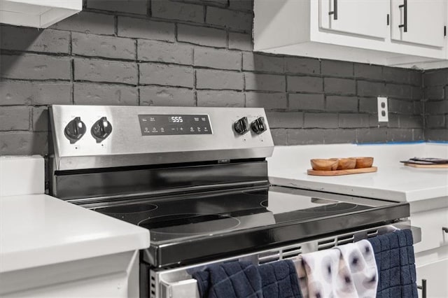 room details featuring white cabinetry and stainless steel electric range oven