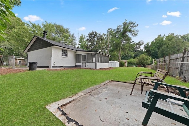 view of yard featuring a sunroom and a patio