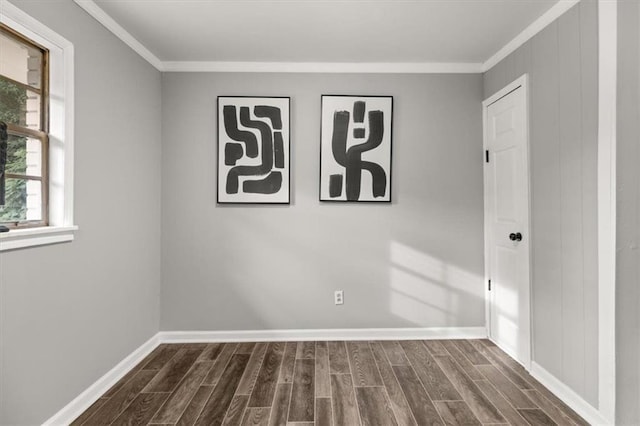 spare room with crown molding and dark hardwood / wood-style floors