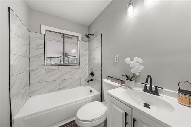 full bathroom with vanity, toilet, tiled shower / bath, and ceiling fan