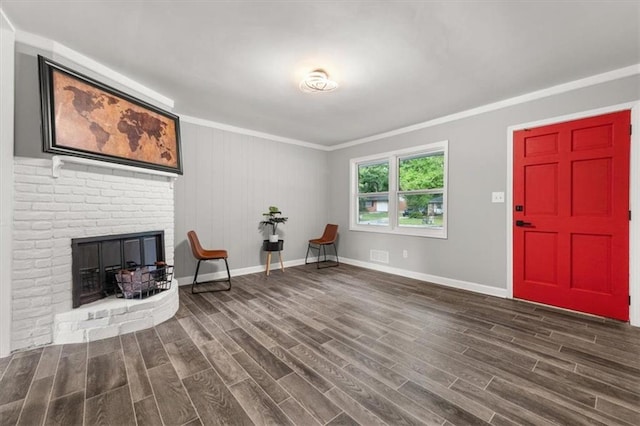 living area featuring a fireplace, dark hardwood / wood-style flooring, and ornamental molding