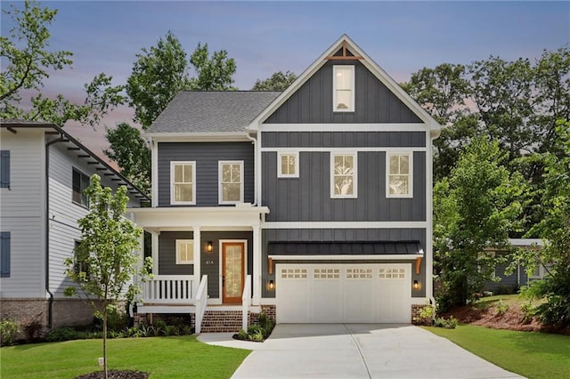 craftsman inspired home with a yard, a porch, and a garage